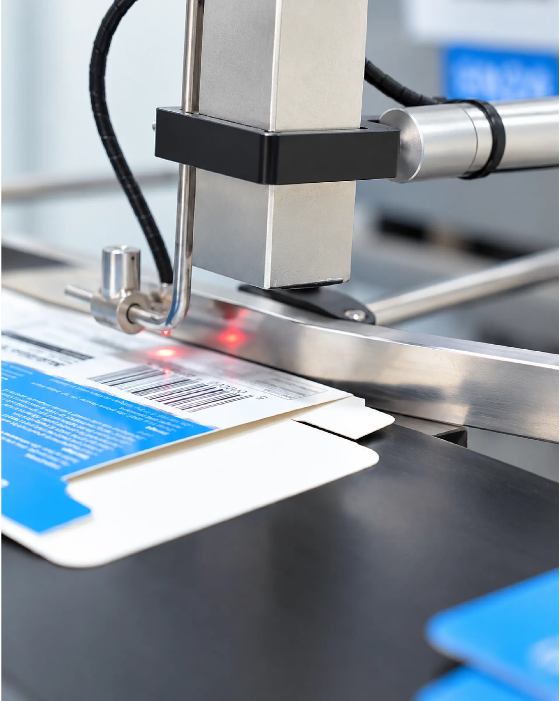 Inkjet coder printing a lot number on a product carton on the packing line
