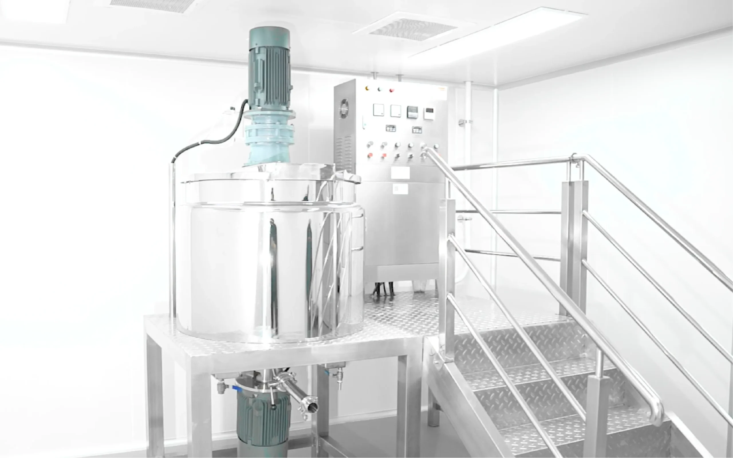 Stainless steel mixing tank and control panel in a clean production room